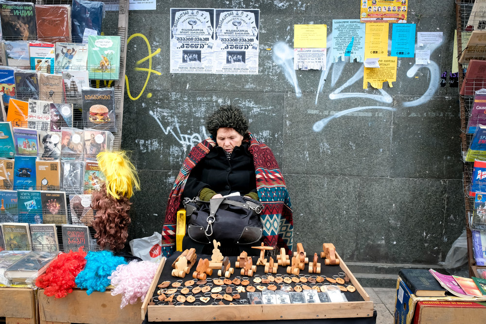a woman selling souvenirs in the streets of Tbilisi